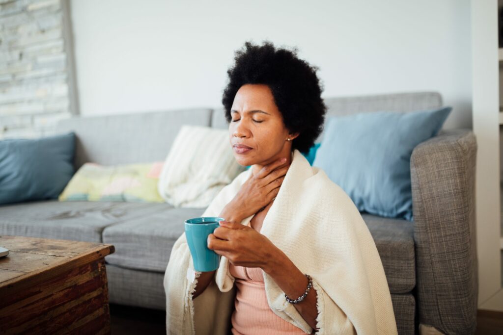 Sick African American woman staying at home